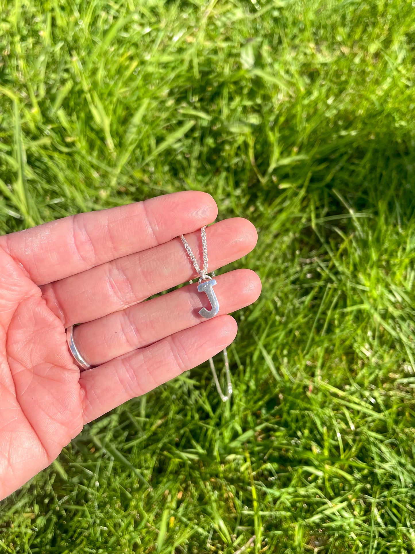 Tiny but chunky silver initial sandcast necklace