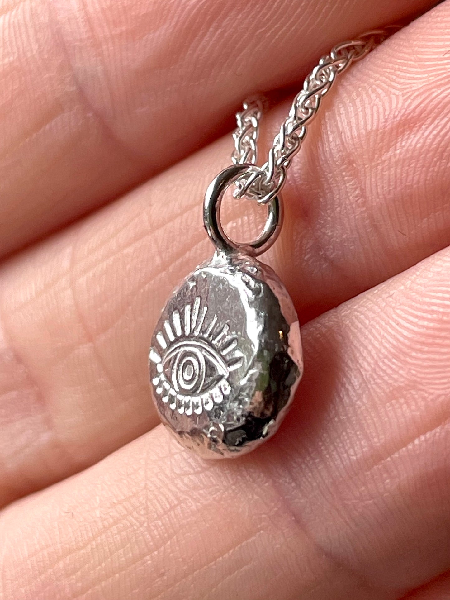 Eye | hand stamped silver pebble