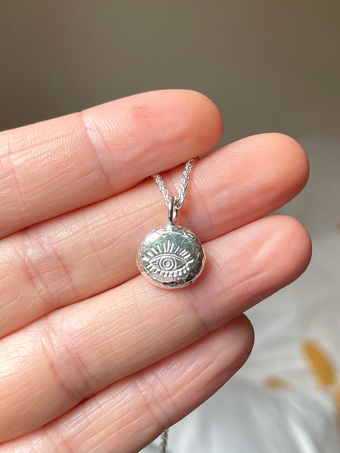 Eye | hand stamped silver pebble
