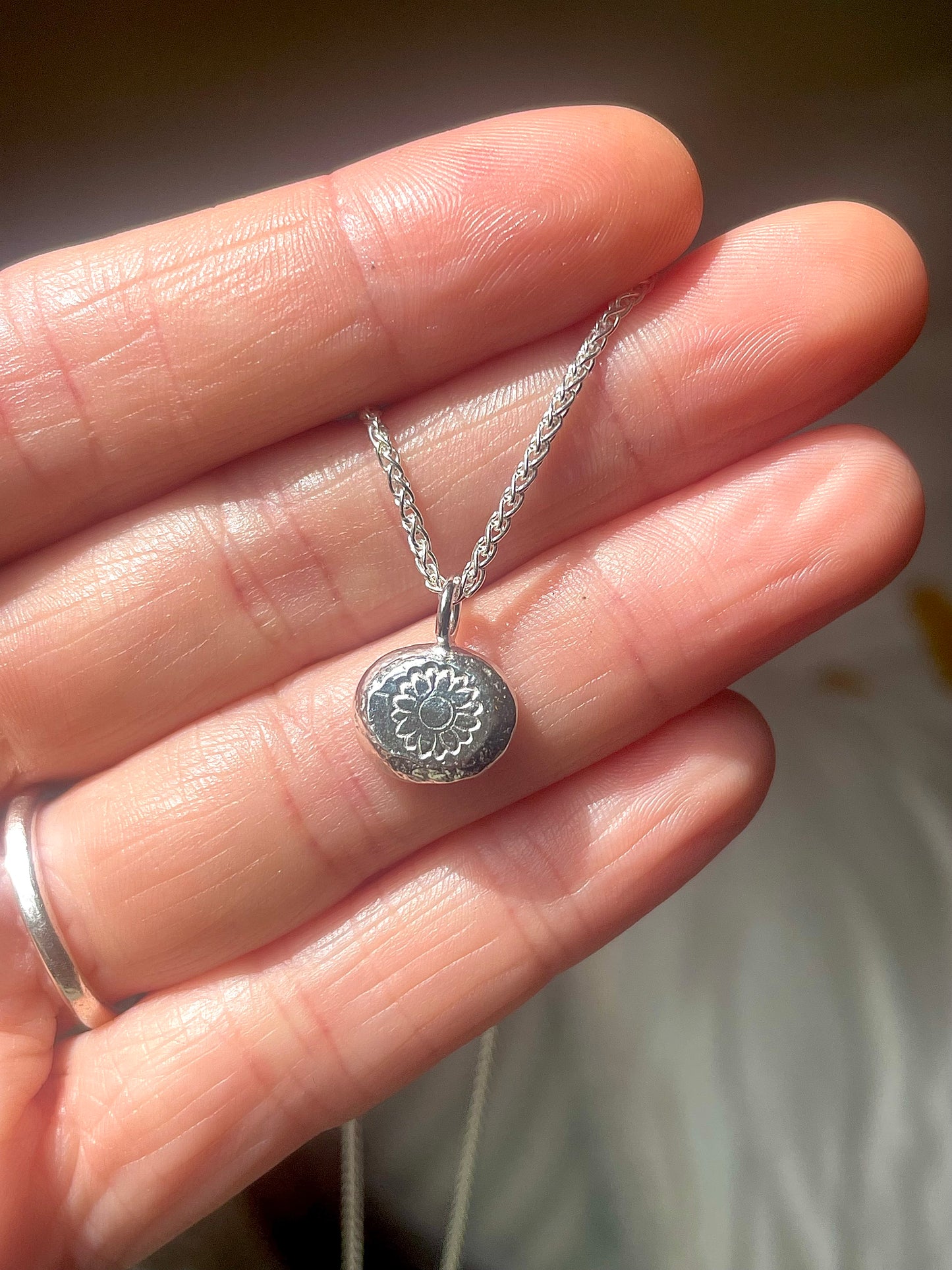 Sunflower | hand stamped silver pebble